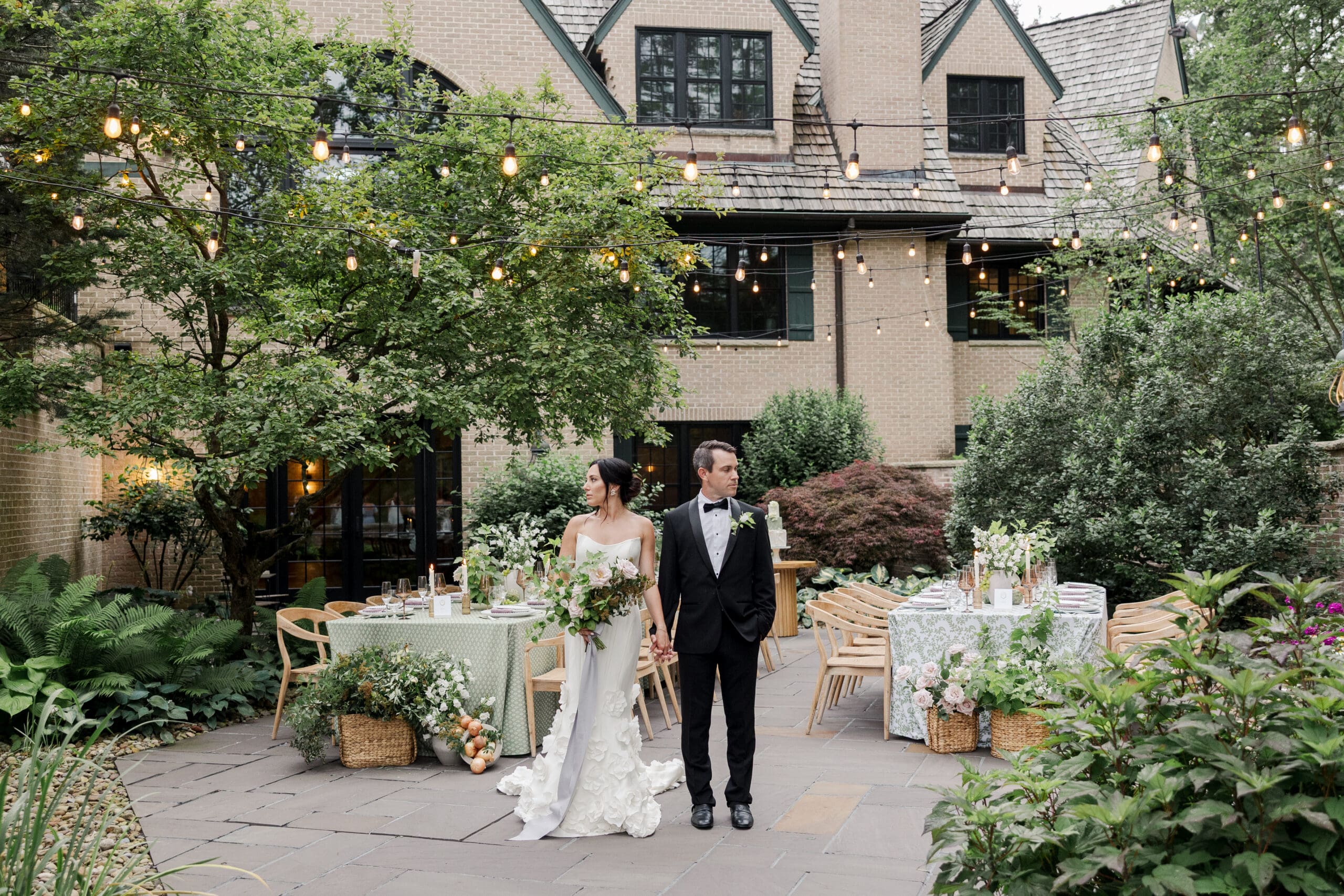 image of a bride and groom holding hands surrounded by greenery